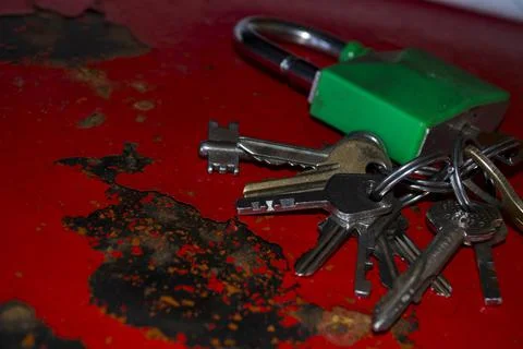 Lock with keys on a red old safe. Stock Photos