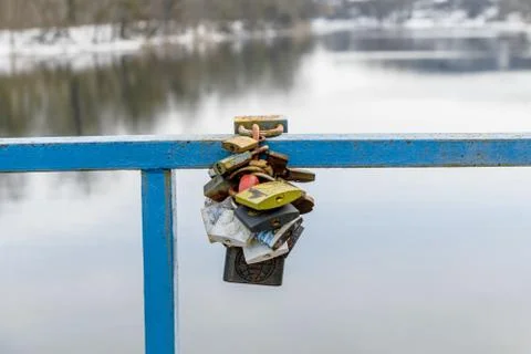Lock in Love. Colored Locks on the Bridge Over the River Stock Photos