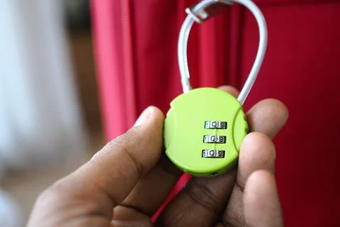 Lock shown on hand before being used on luggage Stock Photos