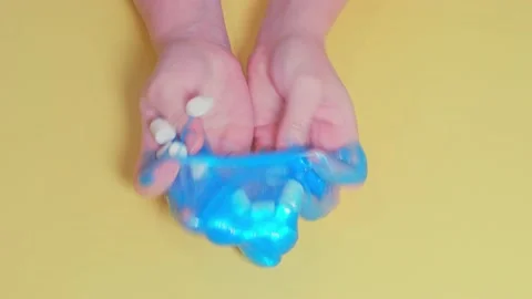 Lockdown activity. Stretching a homemade glitter liquid sticky Blue Slime Stock Footage 164796033