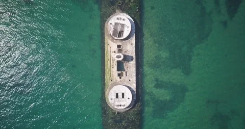Lockdown aerial shot of abandoned large ship amidst turquoise water Stock Footage 122481129