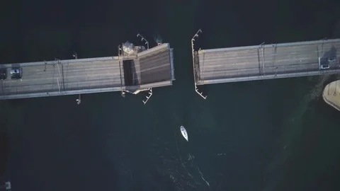 Lockdown aerial view of bascule bridge closing over sea in the city Stock Footage 122402848