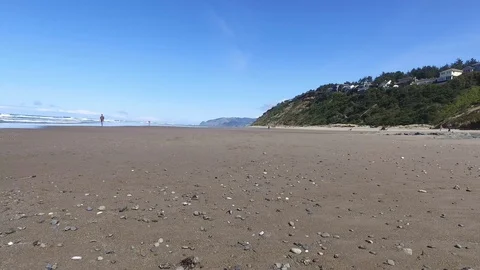 Lockdown of Agates on Sandy Beach with Person Walking Stock Footage 87927179