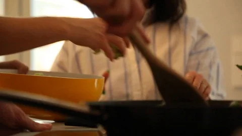 Lockdown close-up shot of friends cooking together on the kitchen counter Stock Footage 114846748