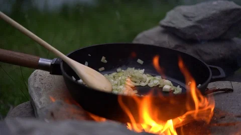 Lockdown close-up shot of a man adding ingredients to the pan Stock Footage 114883154