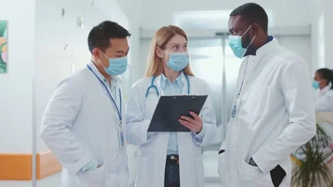 Lockdown. Coronavirus. Asian chief scientist and two doctors wearing face masks Stock Footage 142591059