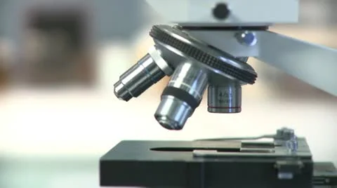 Lockdown, CU, Lab technician's hand placing slide under objectives lens of Stock Footage 10702138
