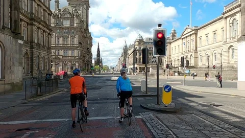 Lockdown Edinburgh Covid 19 Coronavirus cyclist at red traffic light Scotland Stock Footage 129891077