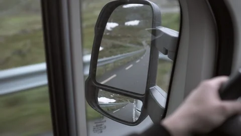 Lockdown of Looking at the Side Mirror While Travelling Through the Mountains - Stock Footage 115547573