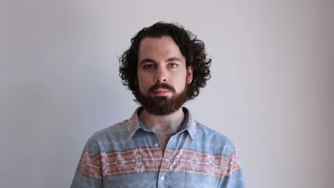 Lockdown portrait shot of confident young man nodding against white background Stock Footage 114859565