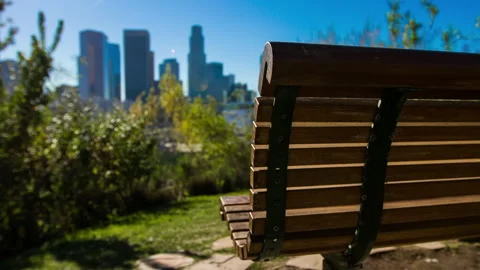 Lockdown Rack Focus Shot Of Empty Wooden Bench Against Skyscrapers In City On 動画素材 243261381