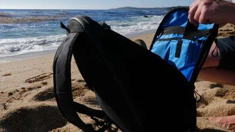 Lockdown of Sandy Beach and a Busy Man Preparing Things in His Backpack Near the Video stock 115713107
