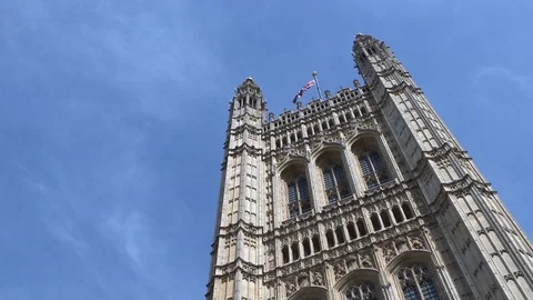 Lockdown shot and low angle view of Westminster Palace with British Flag 스톡 동영상 120433176