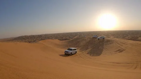 Lockdown Shot Of Car Drifting On Sand In Desert During Sunset - Dubai, United Stock Footage 154666199