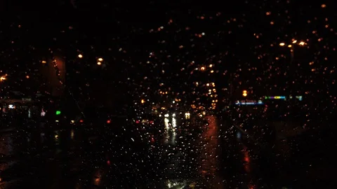 Lockdown shot of city traffic seen through wet window Stock Footage 122395841