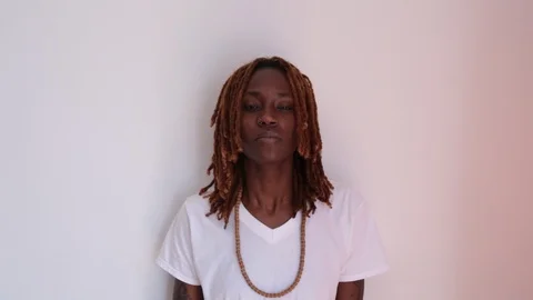 Lockdown shot of confident young hipster standing against white background Stock Footage 114860223