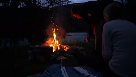 Lockdown shot of a couple camping at the dusk Stock Footage 114883103