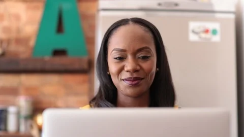 Lockdown shot of freelancer smiling and drinking coffee while working on laptop Stock Footage 114859629