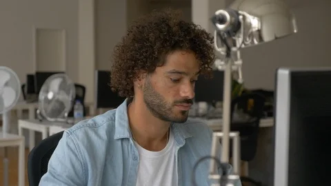 Lockdown shot of handsome young man working on computer and leaving his desk Video stock 114872477