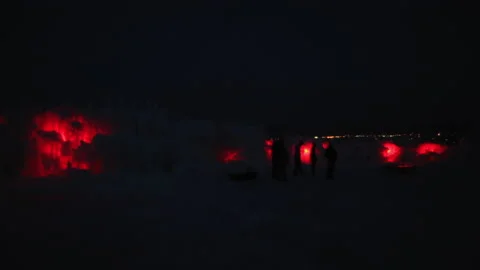 Lockdown Shot Of Illuminated Ice Castles At Night, People Exploring During Stock Footage 160325867