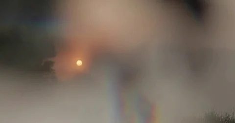 Lockdown shot of lake and trees in foggy weather during sunset Stock Footage