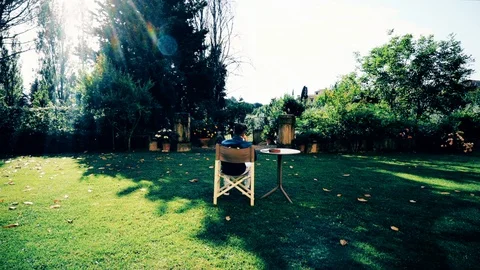 A lockdown shot of a man sitting on a chair in the garden Vídeo Stock 122469455