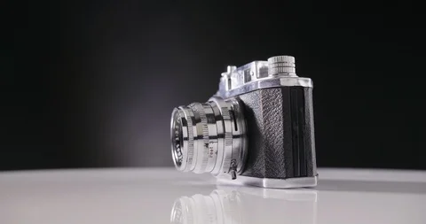 Lockdown Shot Of Oldfashioned Camera Against Black Background Stock Footage 86085051