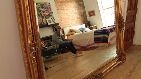 Lockdown shot of reflection of woman using mobile phone and listening music Stock Footage 114860305