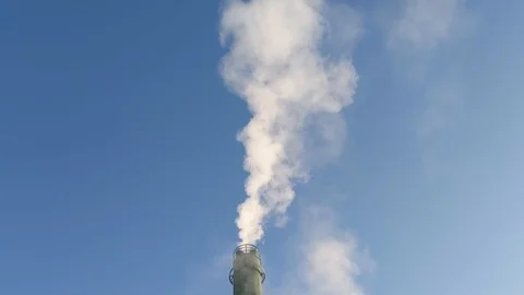 Lockdown shot of smokestack spewing out a stream of smoke Video stock 114880379