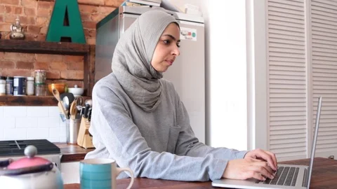 Lockdown shot of thoughtful young freelancer in hijab working on laptop Stock Footage 114860074