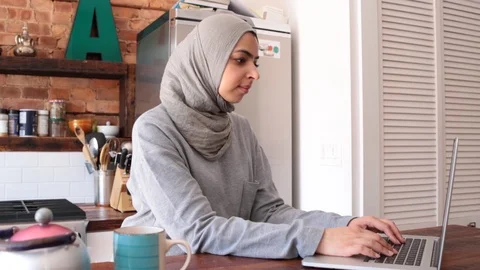 Lockdown shot of thoughtful young freelancer in hijab blogging through laptop Stock Footage 114860079