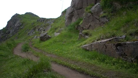 Lockdown shot of two hikers climbing up the hill Stock Footage 114881780