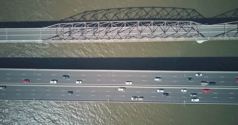 Lockdown shot of vehicles driving on bridge over sea Video stock 122387149
