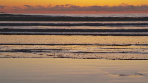 Lockdown Shot Of Waves Reaching Shore At Beach During Sunset Stock Footage 79655240