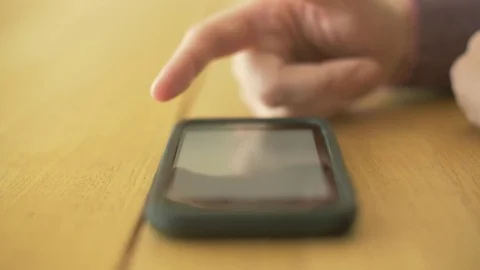 Lockdown Shot Of Woman Scrolling Screen On Smartphone At Table Stock Footage 79657178