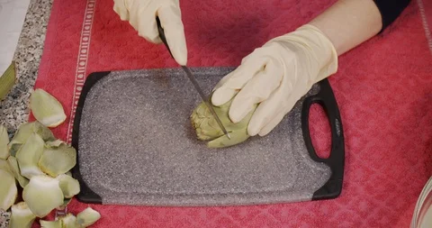 Lockdown shot of woman while cutting artichoke - Healthy Eating Vegetarian Fo Stock Footage 128969346