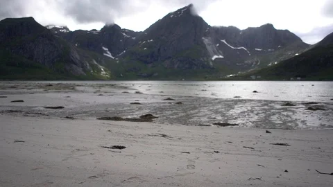 Lockdown shot of a young man walking towards the lakeshore Stock Footage 114881856