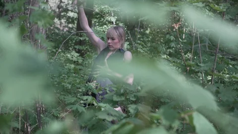 Lockdown shot of young woman dancing in the forest Stock Footage 120155893
