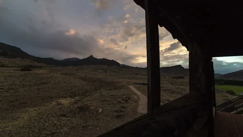 Lockdown Time Lapse Shot Of Clouds Moving Over Old Cabin During Sunset - British Stock Footage 160315273
