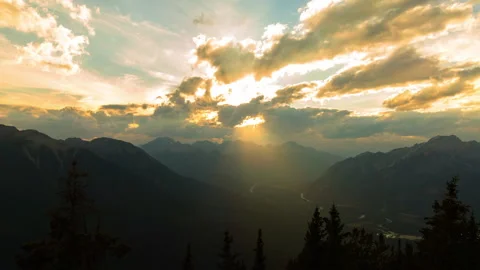 Lockdown Time Lapse Shot Of Clouds Moving Over Rocky Mountains During Sunset - Stock Footage 160322038