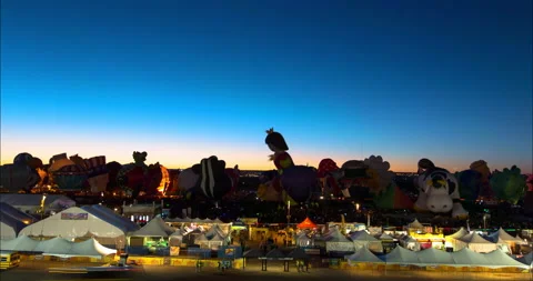Lockdown Time Lapse Shot Of Illuminated Hot Air Balloons Over Landscape In Stock Footage 160328643