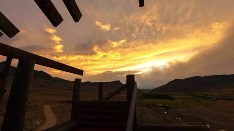 Lockdown Time Lapse Shot Of Orange Clouds Moving Over Landscape During Sunset - Stock Footage 160325297