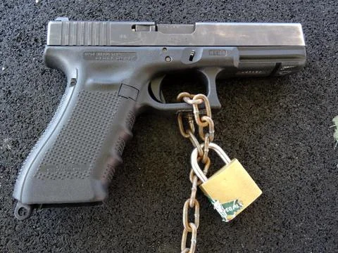 Locked And Chained Glock 17 Handgun Stock Photos