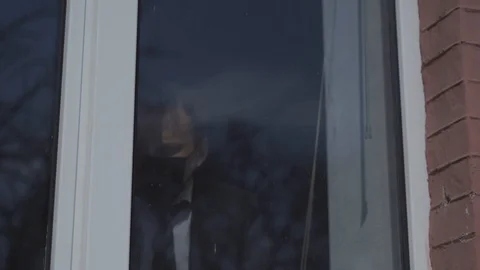 Locked businessman in front of a window Stock Footage 130042795