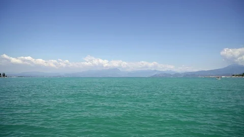 Locked down real time wide shot of lake Garda taken from the waterfront. Lake Stock Footage 122290470