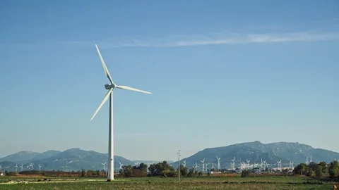 Locked down shot of windmills on background of mountains in Spain Stock-Footage 124931939