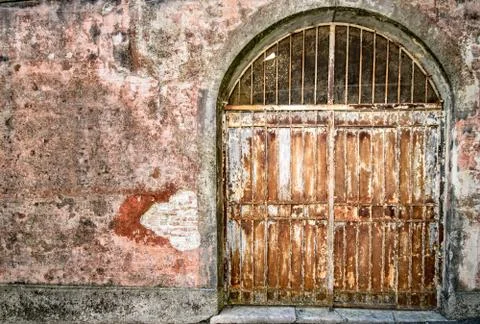 Locked iron gate covered with rust. Stock Photos
