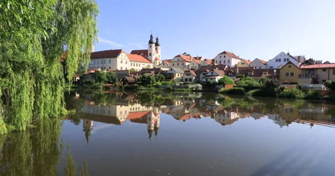 Locked off motion of pond with reflections of old town Telc in the water 動画素材 337984836