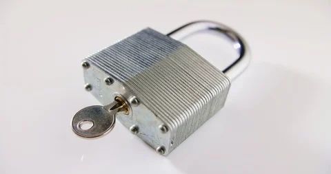 Locked Padlock And Key On Table Representing Cyber Security Stock Footage 92431945