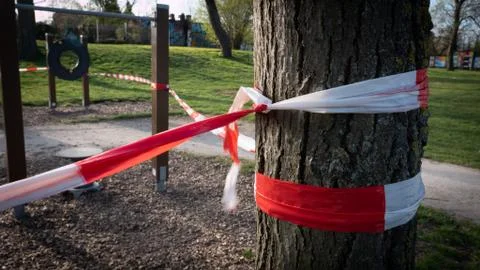 Locked off playground during Corona lockdown, police tape Stock Photos